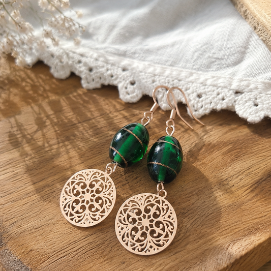 One of a kind oorbellen groene glaskraal met roségouden boho bedel