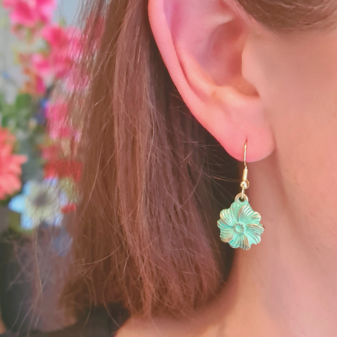 Geoxideerde oorbel in goud met bloemvormige hanger