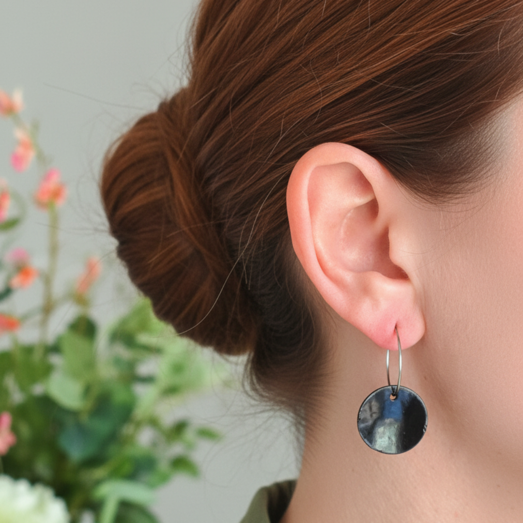 Black circular earring profile shot with updo