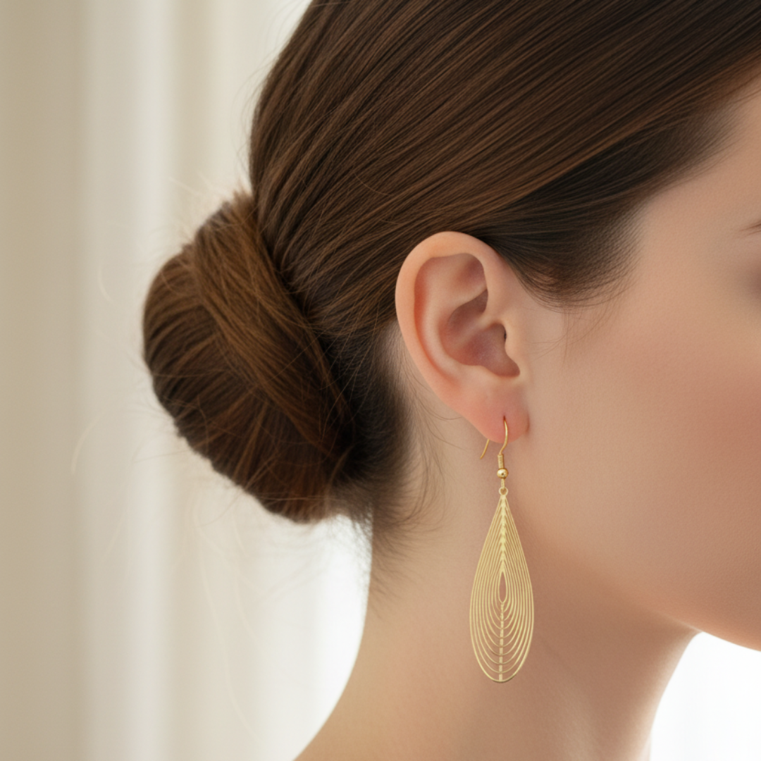 Gold teardrop earrings with enhanced focus and lighting