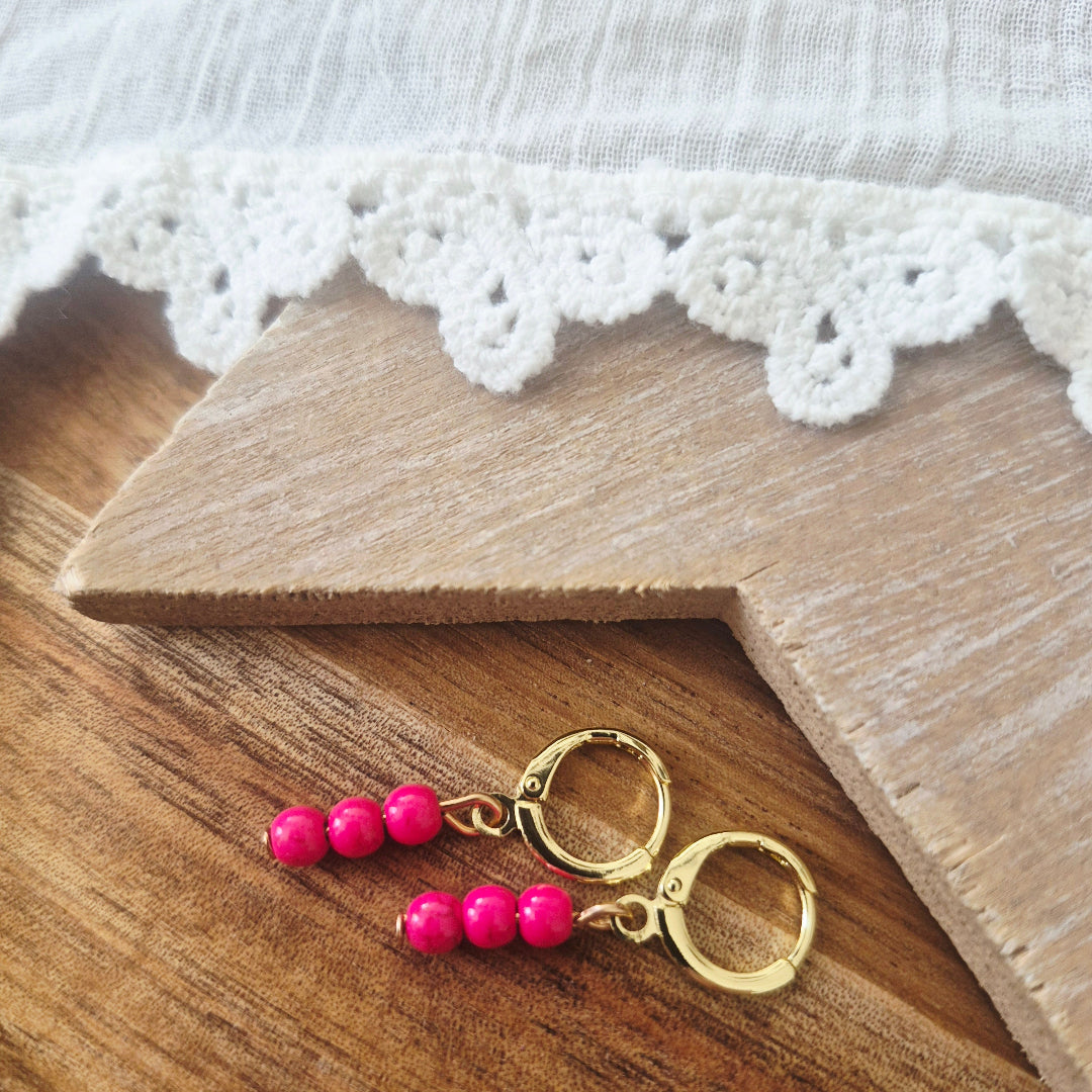 Gouden ringetjes met hotpink kraaltjes nikkelvrij