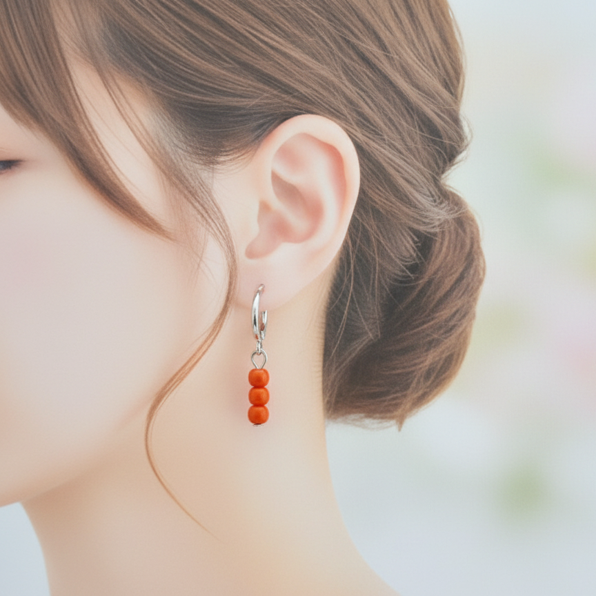 Oranje kraaltjes op zilveren ringetje