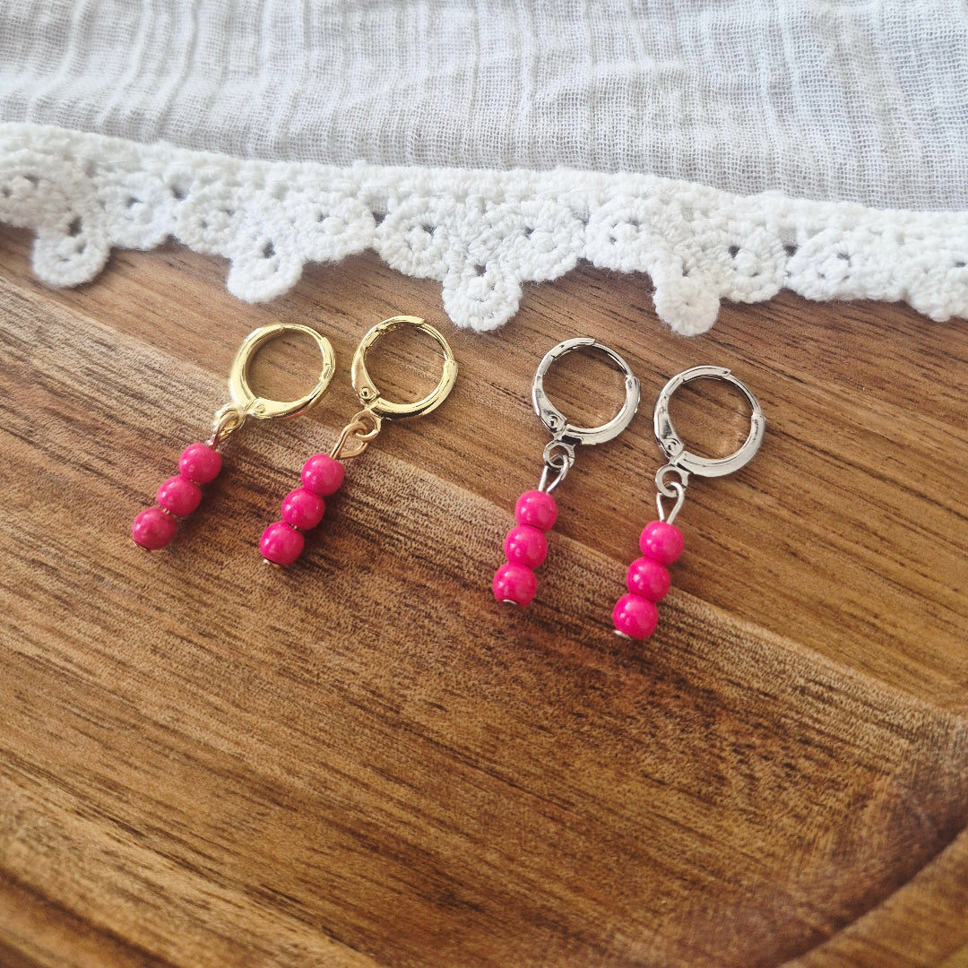 Ringetjes goud en zilver met hotpink kraaltjes vergelijking